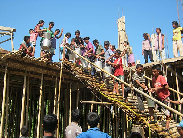 Carrying water up to cure the concrete.